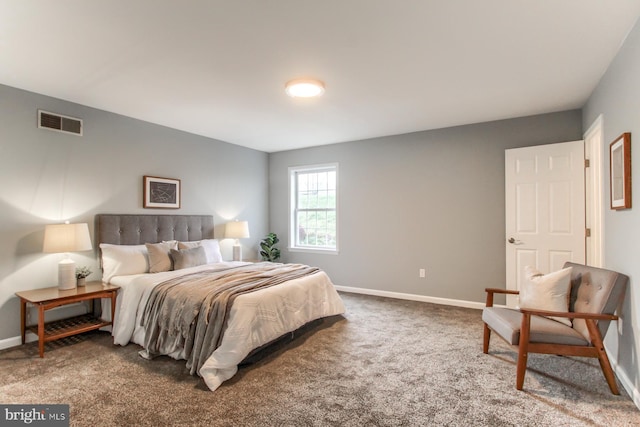 carpeted bedroom featuring baseboards and visible vents