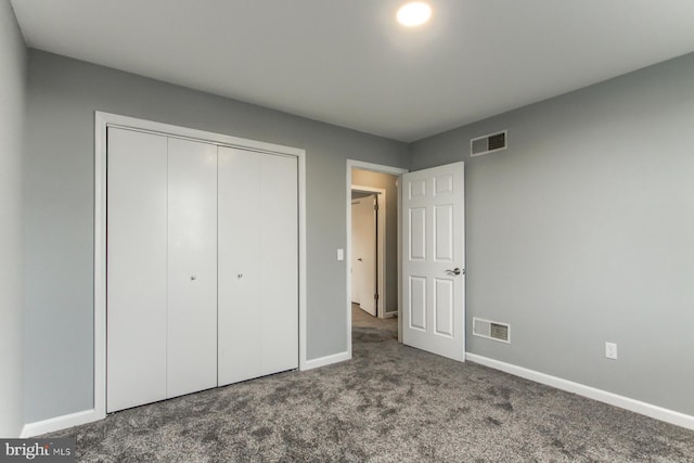 unfurnished bedroom with visible vents, carpet flooring, and baseboards
