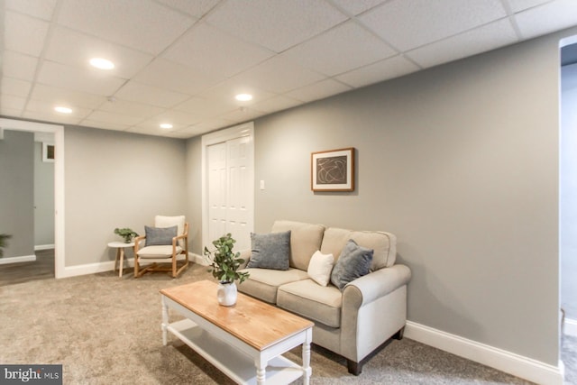 living room featuring carpet, a paneled ceiling, recessed lighting, and baseboards