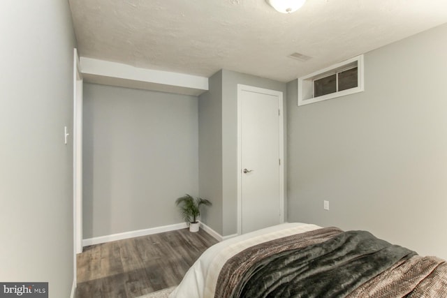 bedroom with wood finished floors and baseboards
