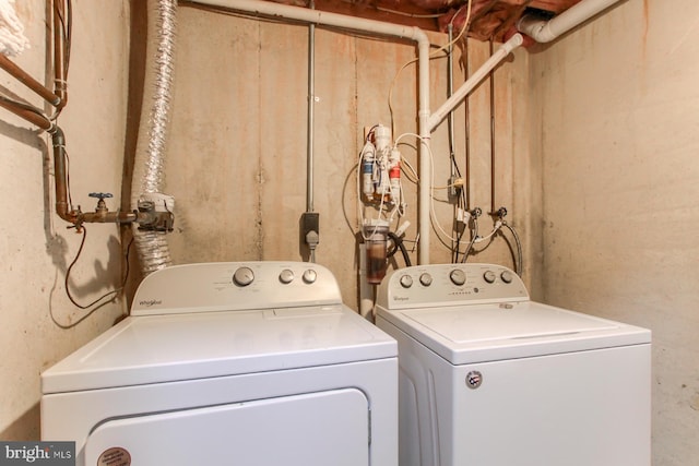 washroom featuring separate washer and dryer and laundry area