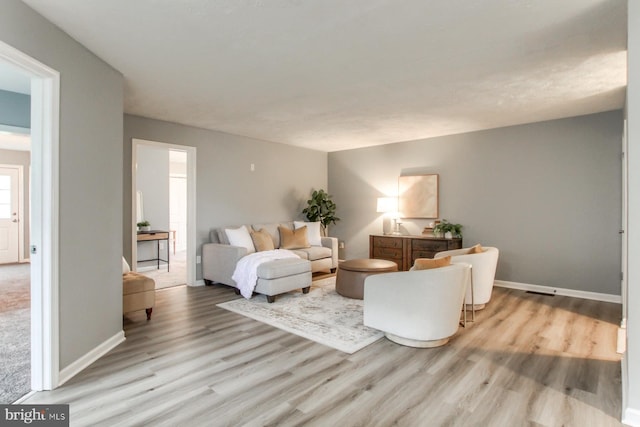 living area featuring wood finished floors and baseboards