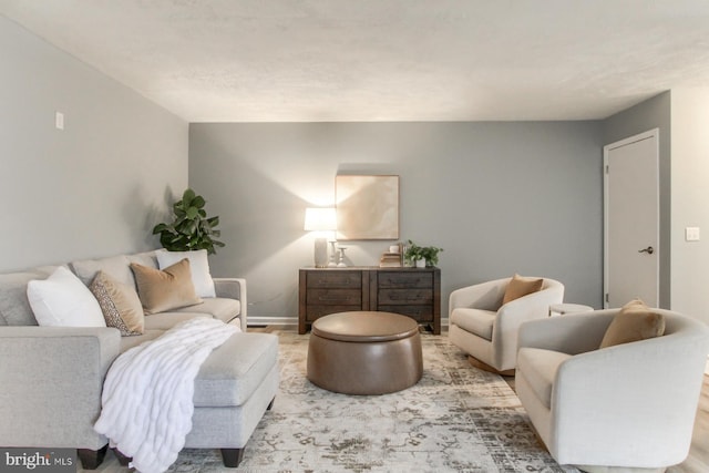 living area featuring baseboards
