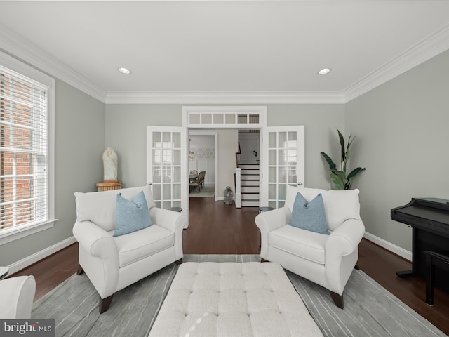 living area featuring crown molding, french doors, wood finished floors, and a healthy amount of sunlight