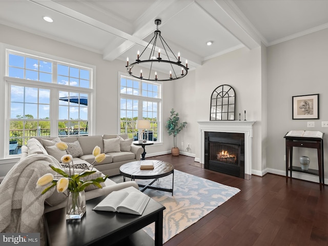 living room with an inviting chandelier, a glass covered fireplace, dark wood finished floors, baseboards, and beamed ceiling