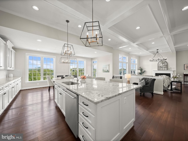 kitchen featuring stainless steel dishwasher, dark wood-style flooring, a chandelier, and a sink