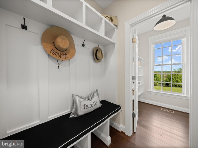 mudroom featuring baseboards, dark wood finished floors, and visible vents