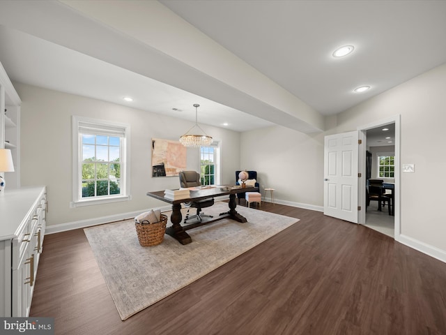 office space featuring baseboards, dark wood-style flooring, and a wealth of natural light
