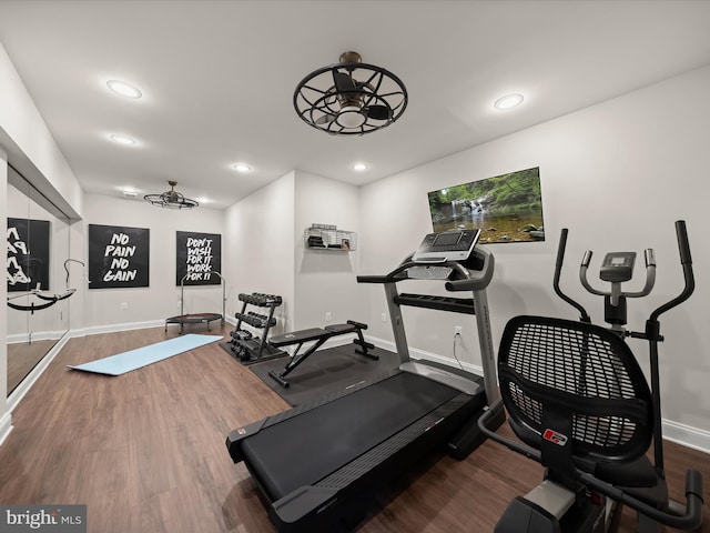 workout area featuring baseboards, recessed lighting, and wood finished floors