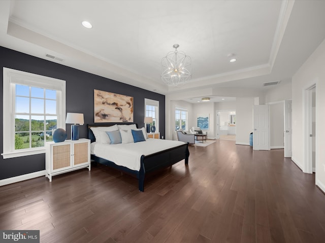 bedroom featuring an inviting chandelier, ornamental molding, recessed lighting, a raised ceiling, and dark wood finished floors