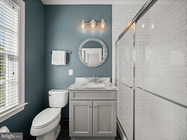 full bathroom with toilet, a shower stall, and vanity