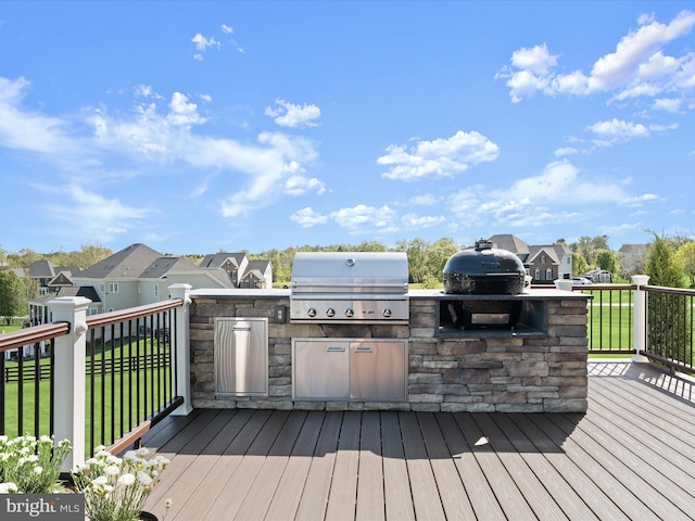 wooden deck with a yard, grilling area, a residential view, and area for grilling