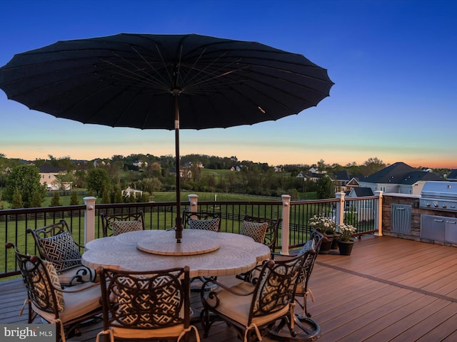 deck featuring outdoor dining space and a grill