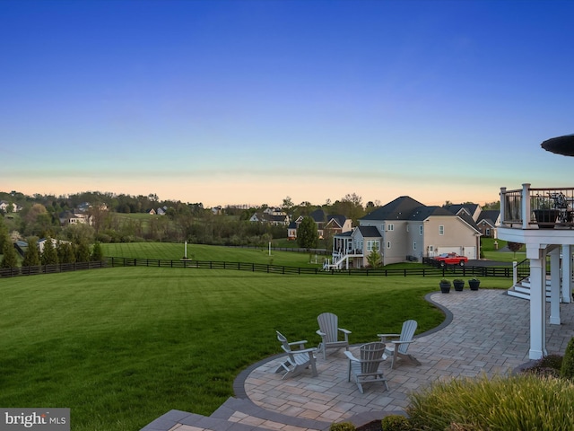 view of yard featuring a residential view, a patio area, a fenced backyard, a fire pit, and stairs