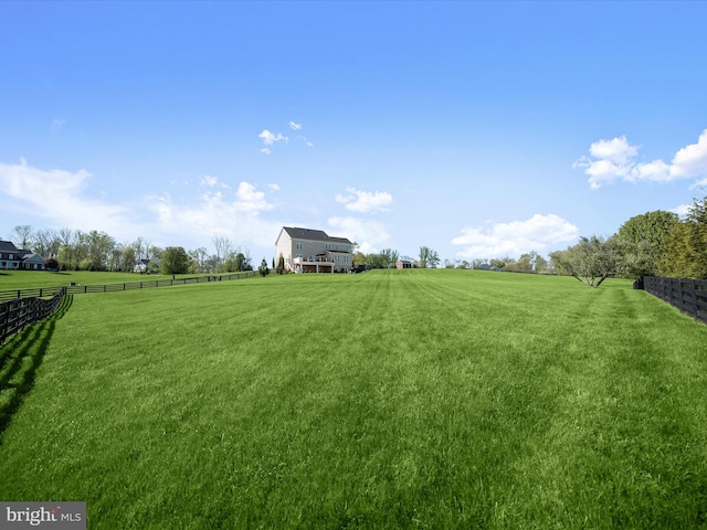 view of yard with a rural view and fence