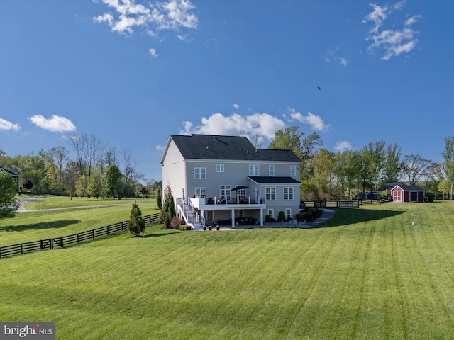 back of house with fence, a wooden deck, stairway, an outbuilding, and a yard