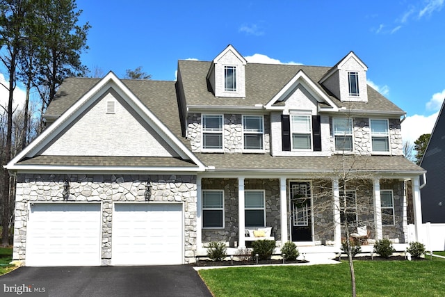 101 Saratoga Ct, North East, MD 21901 - view of front of home with covered porch, aphalt driveway, a garage, stone siding, and a front lawn