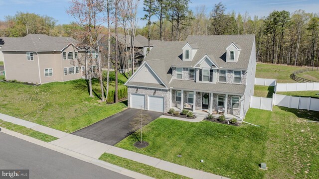 101 Saratoga Ct, North East, MD 21901 - view of front of home featuring driveway, stone siding, covered porch, fence, and a front lawn