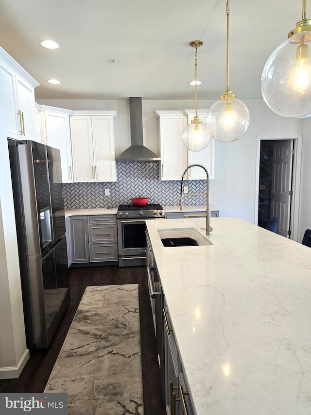 101 Saratoga Ct, North East, MD 21901 - kitchen featuring dark wood-style floors, a sink, light stone counters, wall chimney range hood, and appliances with stainless steel finishes