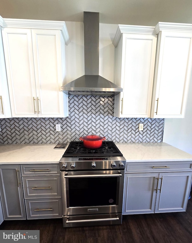 101 Saratoga Ct, North East, MD 21901 - kitchen with light stone countertops, decorative backsplash, wall chimney exhaust hood, white cabinets, and gas range