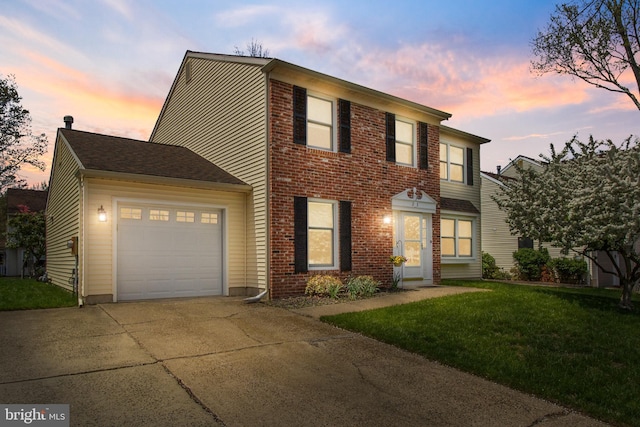 view of front of property with driveway, brick siding, a front yard, and an attached garage
