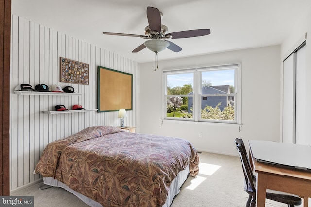 carpeted bedroom with a ceiling fan and baseboards