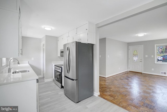 1310 S Columbus St, Arlington, VA 22204 - kitchen featuring a sink, light countertops, baseboards, and stainless steel appliances