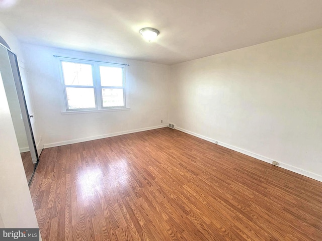 7107 Oakland St, Philadelphia, PA 19149 - empty room with wood finished floors, visible vents, and baseboards