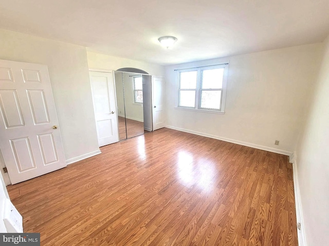 7107 Oakland St, Philadelphia, PA 19149 - unfurnished room featuring baseboards, arched walkways, and wood finished floors