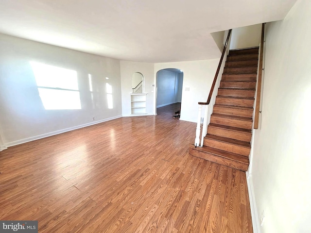 7107 Oakland St, Philadelphia, PA 19149 - interior space featuring arched walkways, stairway, wood finished floors, and baseboards