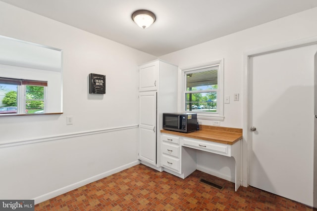 1321 Bayshire Ln, Herndon, VA 20170 - unfurnished office featuring healthy amount of natural light, baseboards, and brick patterned floors