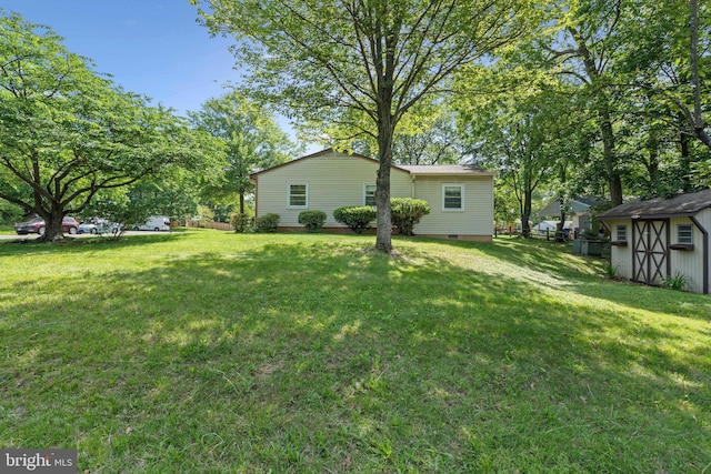 1321 Bayshire Ln, Herndon, VA 20170 - view of grassy yard with an outdoor structure and a storage shed