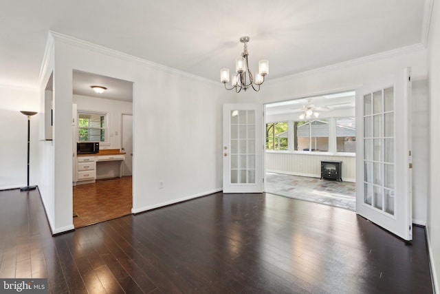 1321 Bayshire Ln, Herndon, VA 20170 - unfurnished dining area with ornamental molding, a chandelier, dark wood-style floors, a wood stove, and french doors