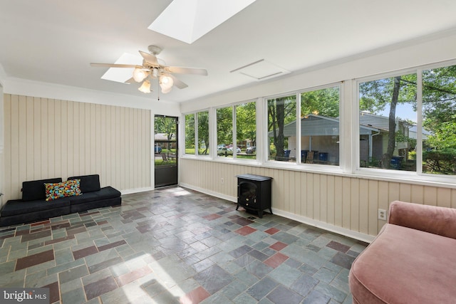 1321 Bayshire Ln, Herndon, VA 20170 - sunroom featuring a wood stove, a skylight, stone finish floors, and baseboards