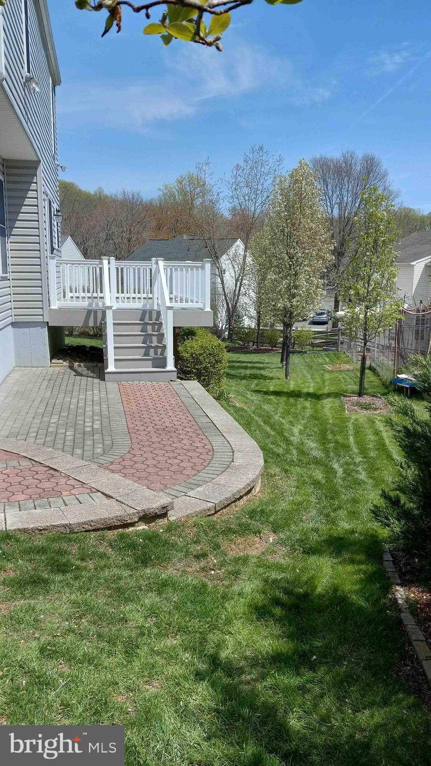 view of yard featuring a wooden deck and stairs