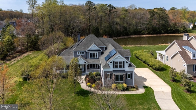 31306 Lakeview Blvd, Lewes, DE 19958 - view of front facade featuring a porch, a chimney, a water view, and a wooded view