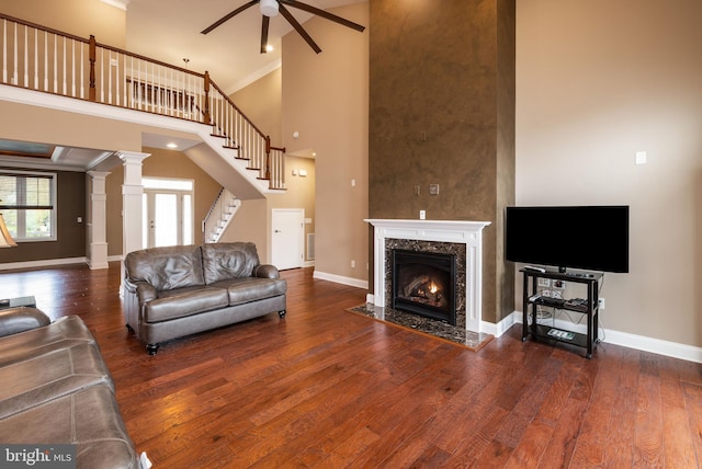 31306 Lakeview Blvd, Lewes, DE 19958 - living room featuring stairway, baseboards, a towering ceiling, wood finished floors, and a ceiling fan