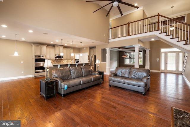 31306 Lakeview Blvd, Lewes, DE 19958 - living room with baseboards, decorative columns, ceiling fan, and dark wood-style flooring