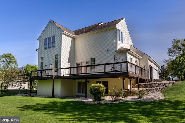 rear view of house featuring a yard and a deck