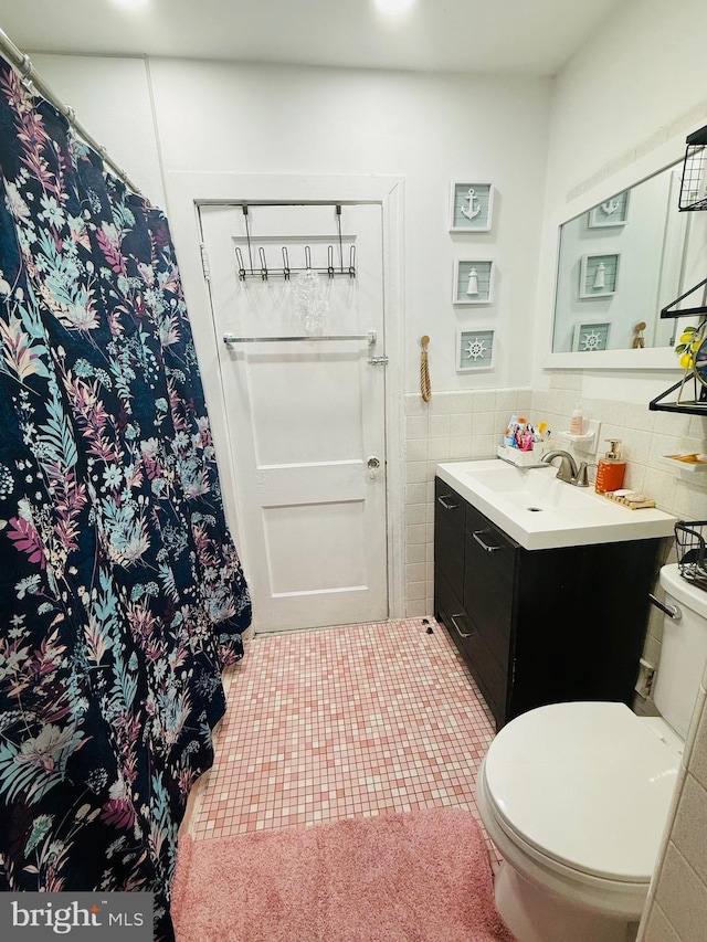 5625 Loretto Ave, Philadelphia, PA 19124 - bathroom with vanity, tile patterned flooring, toilet, and tile walls