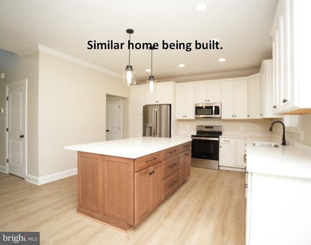 kitchen featuring light wood-type flooring, stainless steel appliances, ornamental molding, and a sink