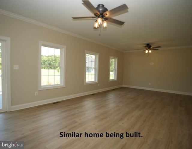 empty room with ornamental molding, ceiling fan, and a wealth of natural light