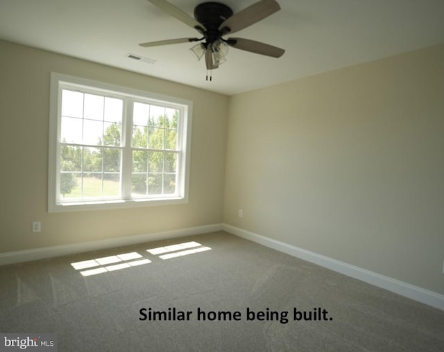 unfurnished room featuring a ceiling fan, visible vents, carpet floors, and baseboards