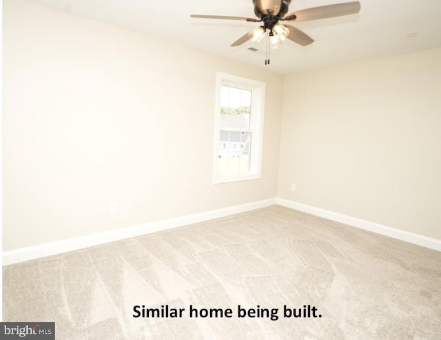 carpeted empty room featuring ceiling fan and baseboards