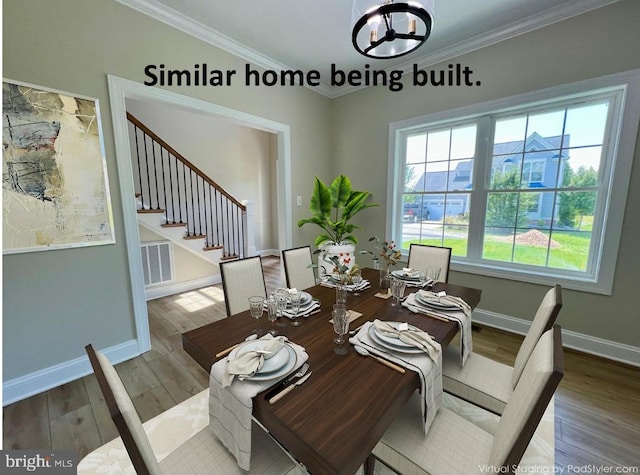 dining area with wood finished floors, stairs, a chandelier, ornamental molding, and baseboards