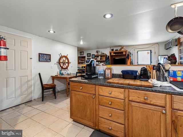 kitchen featuring light tile patterned flooring, brown cabinets, and recessed lighting
