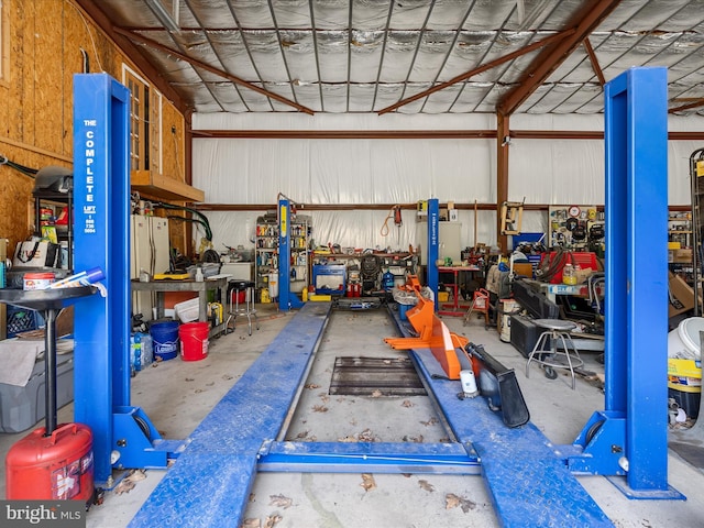 garage with a workshop area and metal wall
