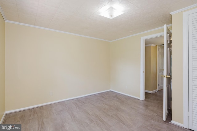 empty room with baseboards and ornamental molding