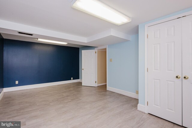 finished below grade area featuring baseboards and visible vents