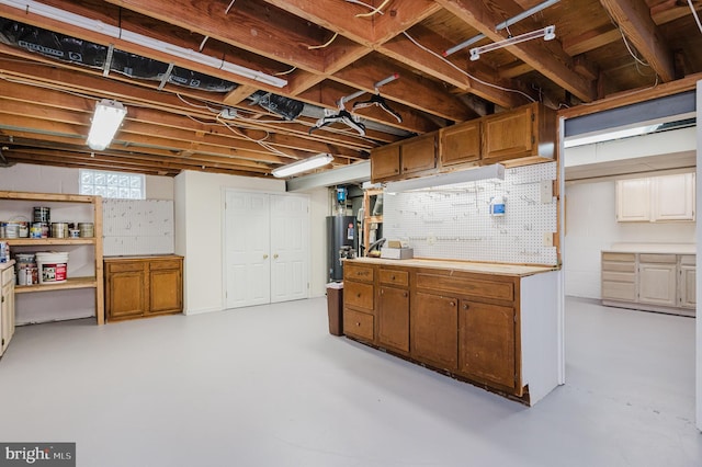 below grade area with water heater and a workshop area